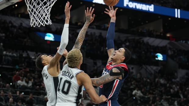 Washington Wizards forward Kyle Kuzma (33) shoots over San Antonio Spurs center Victor Wembanyama (1) and forward Jeremy Sochan (10) in the second half at Frost Bank Center. Mandatory Credit: Daniel Dunn-USA TODAY Sports